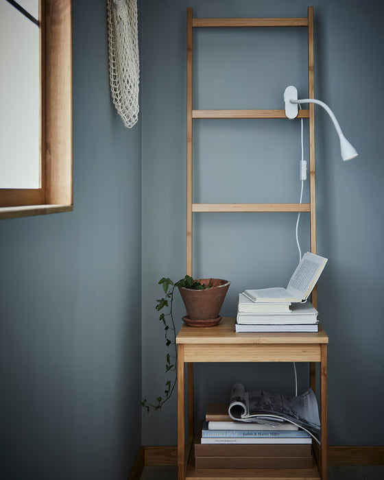 IKEA NÄVLINGE white adjustable clamp lamp on blue room ladder shelf with books and plant