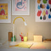 NÄVLINGE LED desk lamp in yellow/white on a modern desk-30574718