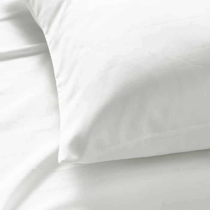 Close-up of IKEA NATTJASMIN white pillowcase fabric showing silky cotton-lyocell sateen texture