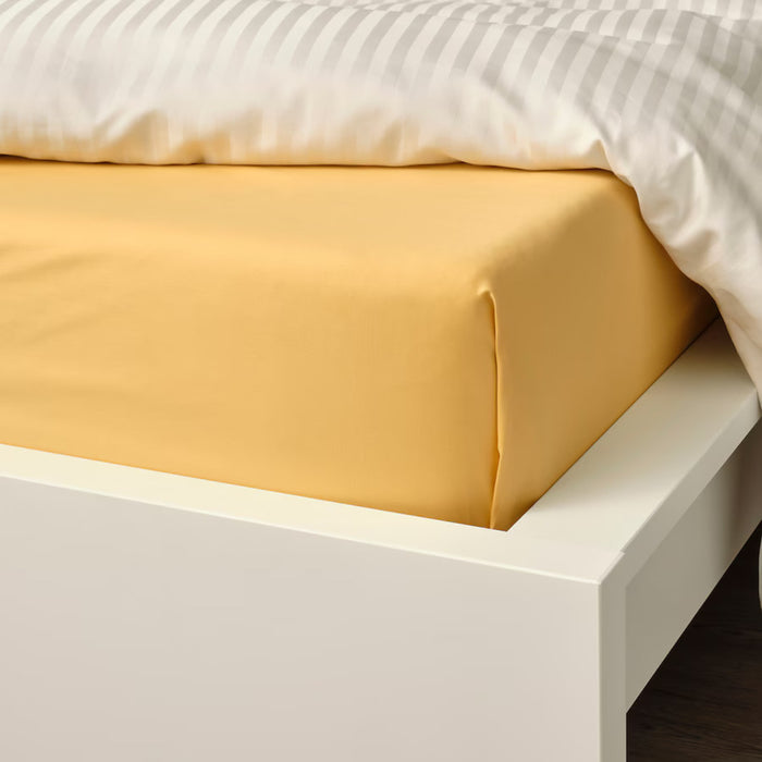 IKEA NATTJASMIN yellow sheet, 150x260 cm, neatly folded on a bed -70500674