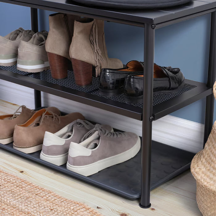 IKEA NIPÅSEN black shoe shelf holding multiple pairs of footwear three-tier storage close-up