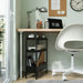 IKEA NISSAFORS black rolling trolley used as bathroom organiser in small space