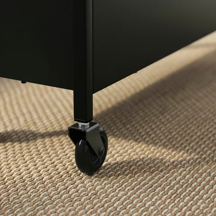 IKEA NISSAFORS black metal trolley on woven rug showing sturdy construction and wheel mobility