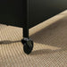 IKEA NISSAFORS black metal trolley on woven rug showing sturdy construction and wheel mobility