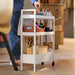 IKEA NISSAFORS white trolley placed beside armchair with accessories