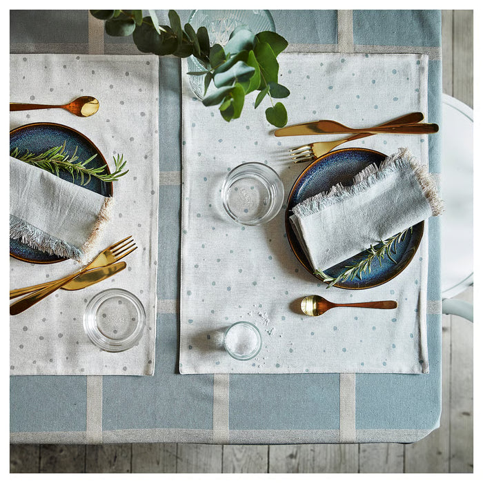 IKEA NISSÖGA blue tablecloth set on dining table with plates, cutlery and glasses