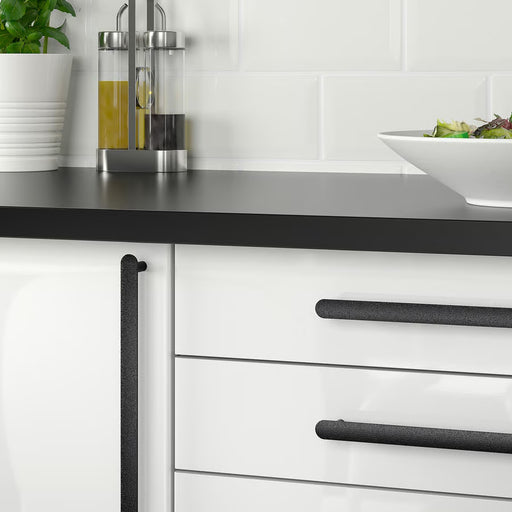 IKEA NYDALA black handles fitted on white kitchen drawers, modern setting