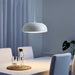  IKEA NYMÅNE white pendant lamp above white dining table with blue curtains and indoor plant