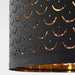 NYMÖ black lamp shade with brass trim hanging over a minimalist dining table in a bright Scandinavian interior.