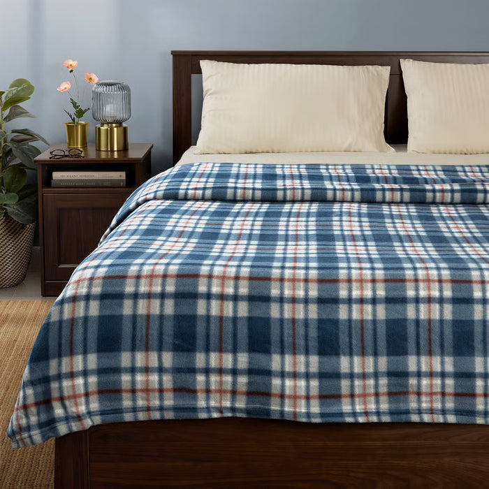 IKEA ODENSLÄTA blue and red check blanket spread over bed with white sheets