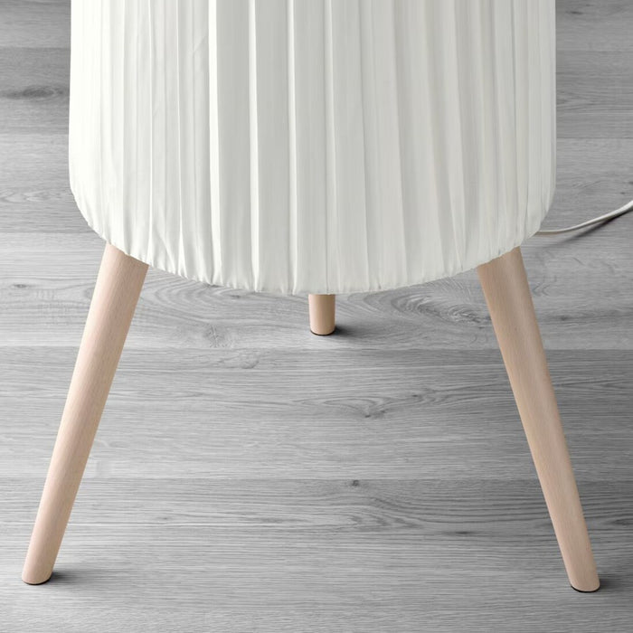 Floor view of ÖKENSAND floor lamp in beech and white, complementing a wooden floor and furniture 80541532