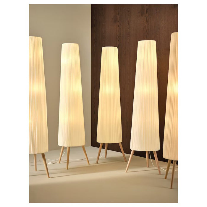 Floor view of ÖKENSAND floor lamp in beech and white, complementing a wooden floor and furniture 80541532