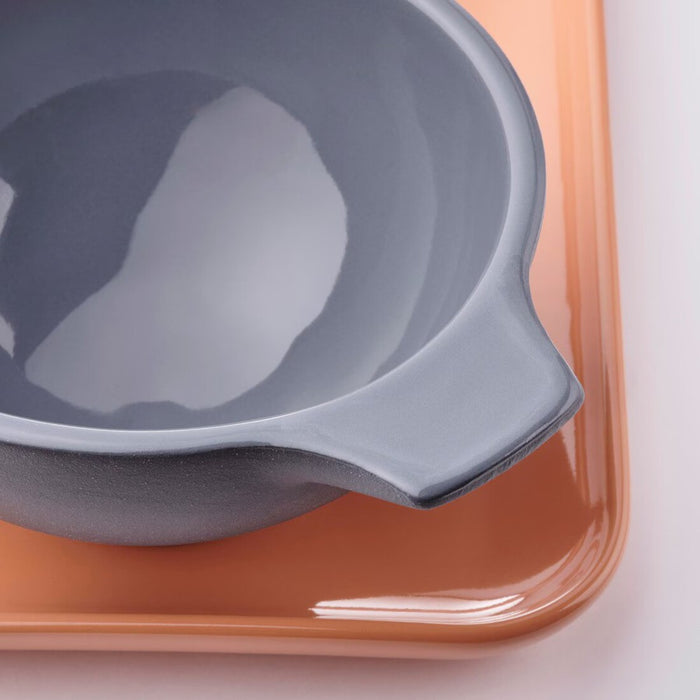 "Close-up of IKEA ÖMSESIDIG stoneware tray with grey and orange bowls"