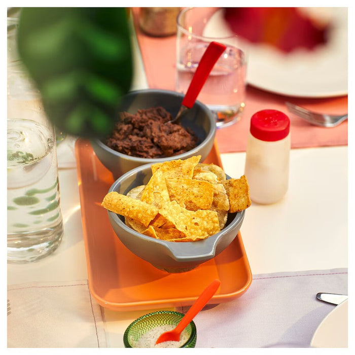 "Serving tray with two bowls filled with snacks on a dining table"