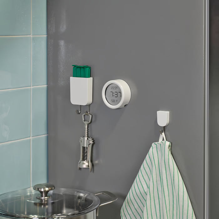 IKEA ÖRNVRÅK white clock mounted near bathroom mirror showing time temperature and humidity display