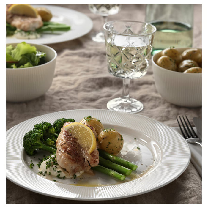 IKEA OFANTLIGT white bowl styled with fish vegetables and wine glass in elegant dinner setting