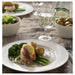 IKEA OFANTLIGT white bowl styled with fish vegetables and wine glass in elegant dinner setting