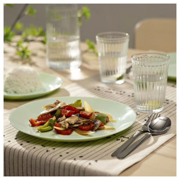 A round, light green ceramic plate with a glossy finish and a smooth surface, designed for serving meals or snacks, placed against a neutral background."
