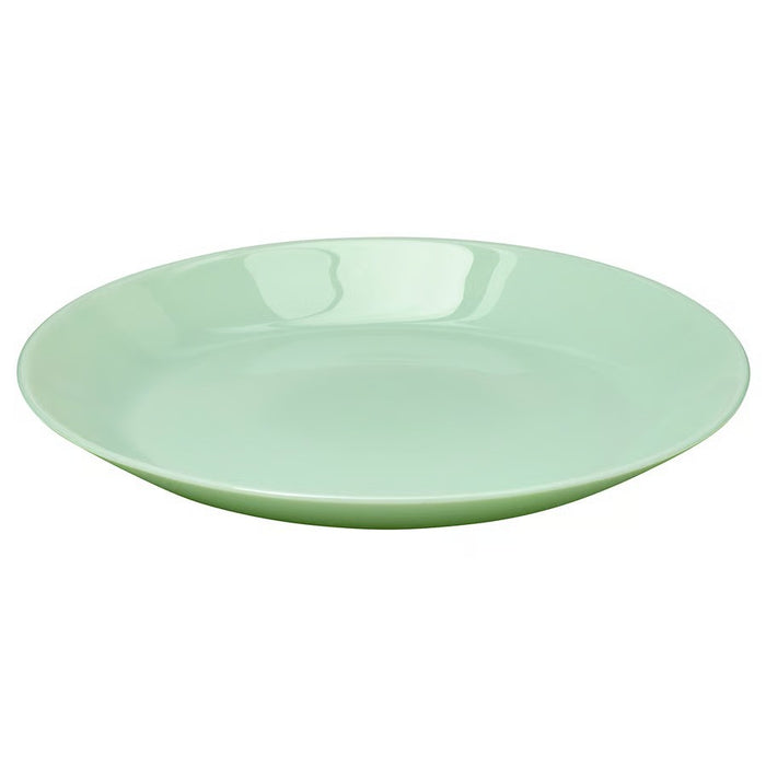 A round, light green ceramic plate with a glossy finish and a smooth surface, ideal for serving meals or snacks."