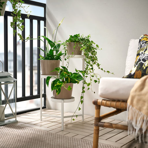 IKEA OLIVBLAD off-white plant stand styled on a balcony with outdoor plants