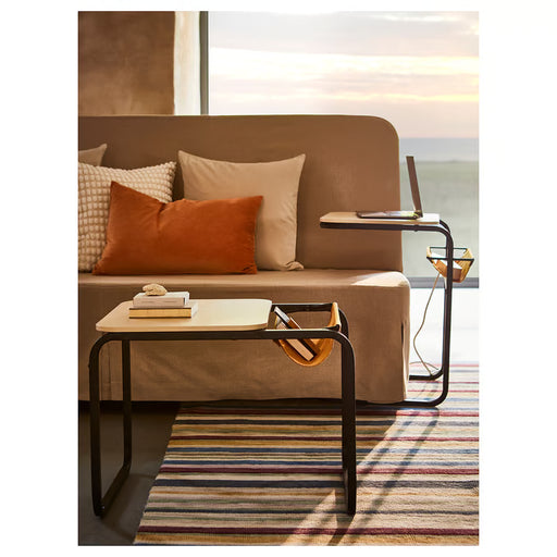 IKEA OLSERÖD side table beside brown sofa with colourful cushions and striped rug in living room