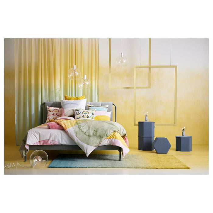 "Vibrant and lightweight IKEA OLYMPTISTEL bedding set on a queen-sized bed"
