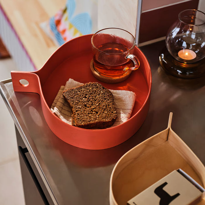 IKEA OMMJÄNGE red wooden tray styled with tea, bread and candle on dining table