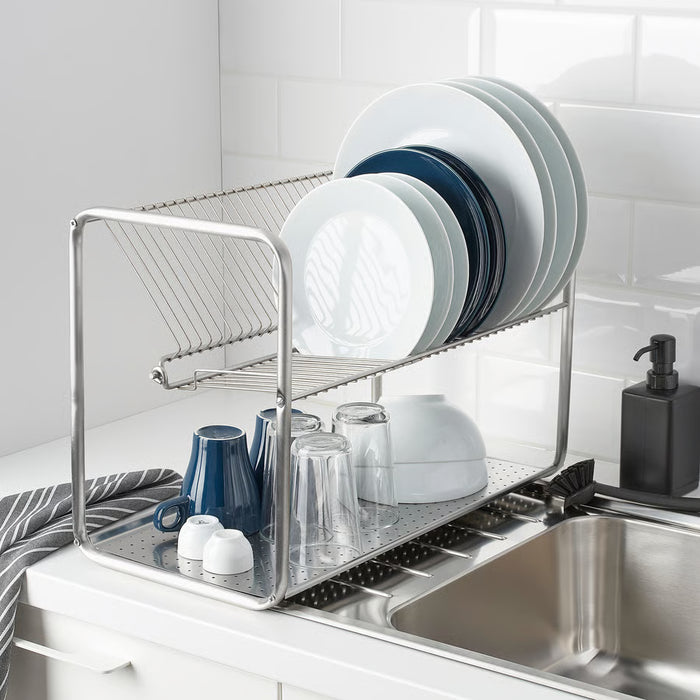  IKEA ORDNING silver dish drainer holding white plates blue bowls and glasses over sink