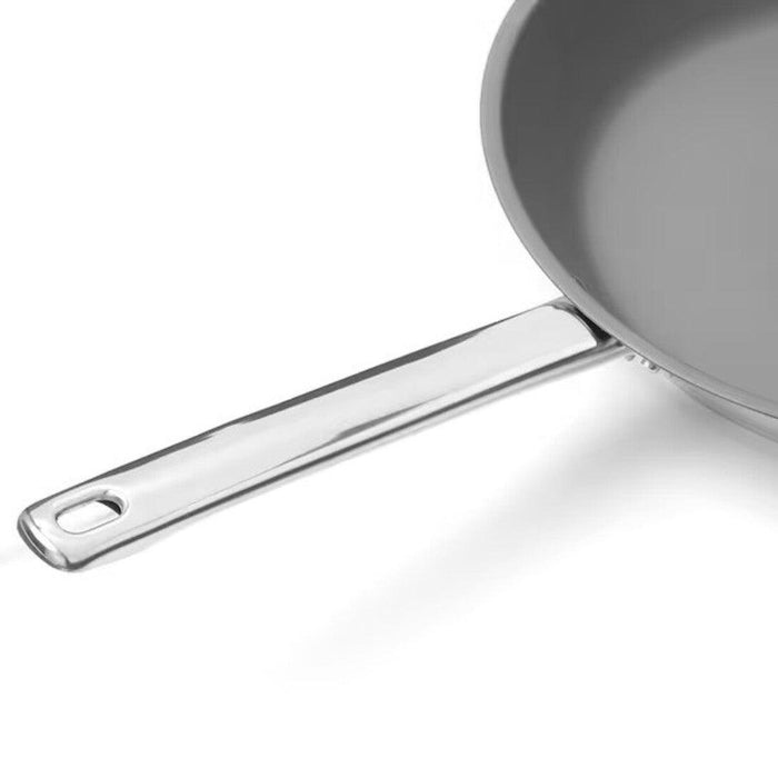 Gray frying pan with a silver handle on a white background