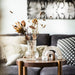 IKEA PÅDRAG clear glass vase with dried flowers on wooden side table in living room with dark sofa