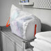  IKEA PÄRKLA white mesh laundry bag with orange straps stored on a shelf