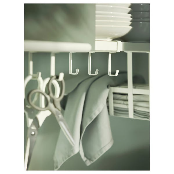 IKEA PÅLYCKE white hook rack clipped under kitchen shelf with utensils hanging in use