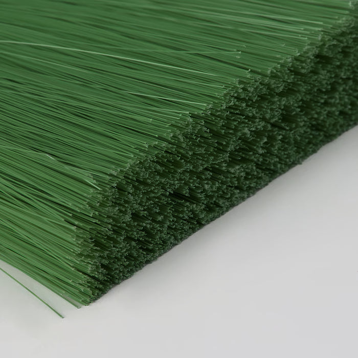 Close-up of IKEA PEPPRIG green broom bristles PET plastic dense texture
