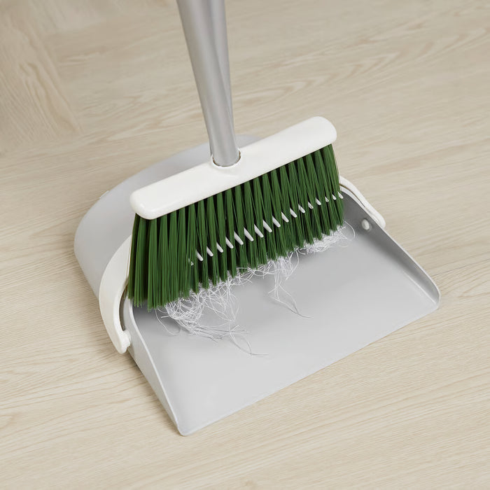 IKEA PEPPRIG dustpan and broom set grey dustpan with green bristles freestanding on wooden floor
