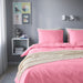 IKEA duvet cover with matching pillowcases on a bed-30579141