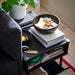 IKEA PINNLILJA acacia bowls on black table styled with snacks in a living room setting