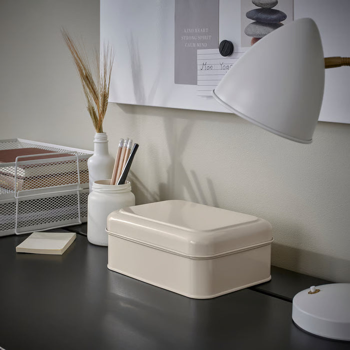  IKEA PLOGFÅRA light beige storage box on desk with lamp, pens, and plant — styled home office setting
