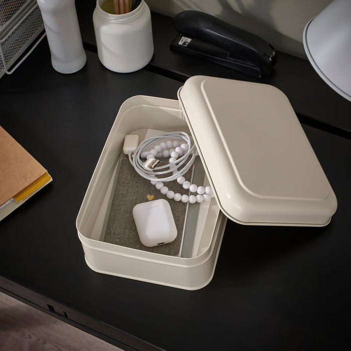  IKEA PLOGFÅRA storage box with lid open on dark desk, holding computer mouse, charging cord and pens