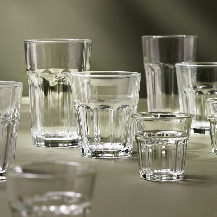 IKEA POKAL clear glasses in multiple sizes arranged on green cloth showing classic ridged design