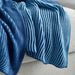 Close-up of the IKEA PRAKTFJÄRIL blue throw, showing its soft texture. 10582842