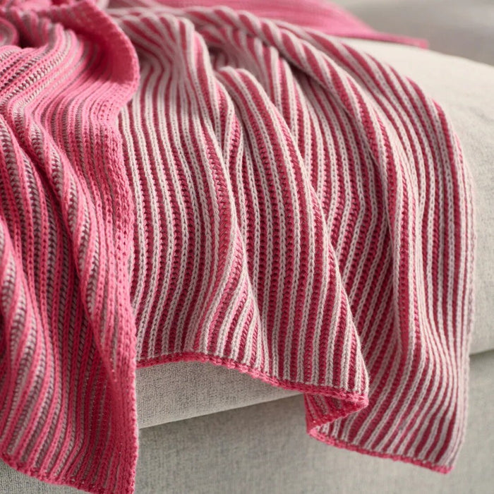 Close-up of IKEA PRAKTFJÄRIL pink throw, soft fabric draped over a sofa-50582840