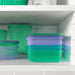 Two stackable IKEA PRUTA plastic containers (22x14x5 cm) in pastel lilac and green colors, ideal for meal prep and lunch storage. 40596710