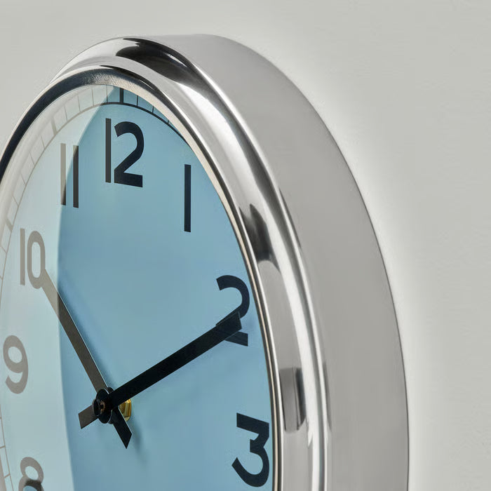 Close-up of IKEA PUGG turquoise wall clock dial and steel frame detailing