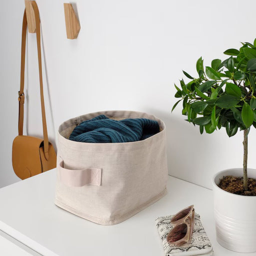 Neatly organized items inside the versatile textile/beige storage solution.