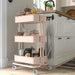 IKEA RÅSKOG pink trolley in kitchen setting holding spice jars and cooking essentials