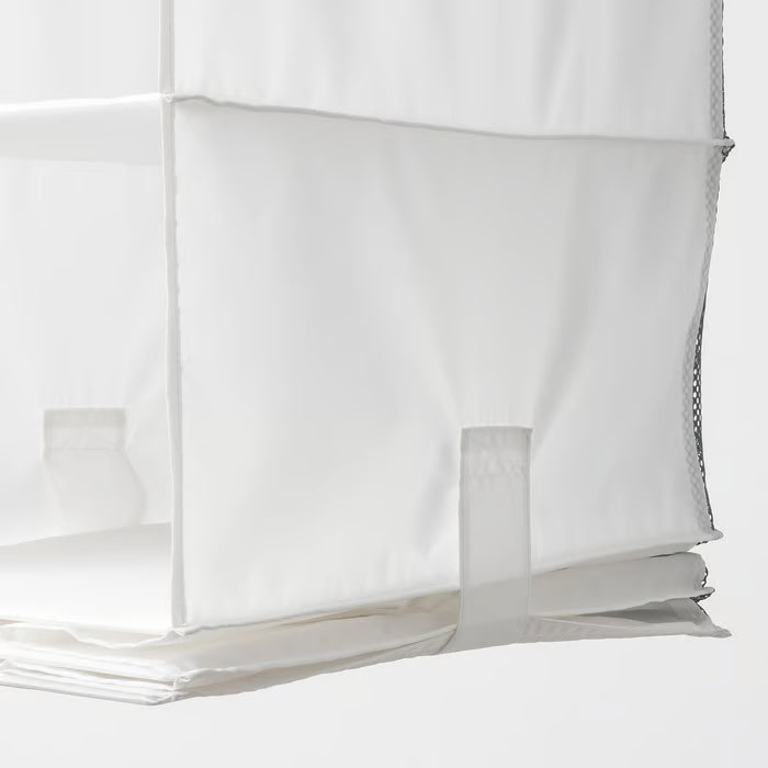 Close-up of IKEA RASSLA white hanging storage showing touch-and-close fasteners on sides