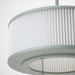 Close-up of the pleated shade on the grey-green IKEA REMTÅNG Pendant Lamp, emitting soft, mood-enhancing light