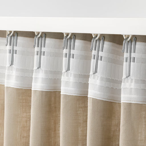 Close-up of an IKEA RIKTIG steel curtain hook showing the pleating hook design