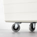 IKEA RILL grey castor in use under a coffee table on wooden floor demonstrating smooth movement

