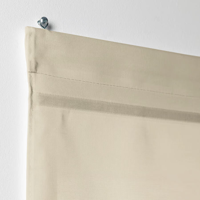 Close-up of IKEA RINGBLOMMA beige roman blind magnetic anchor and mounting detai